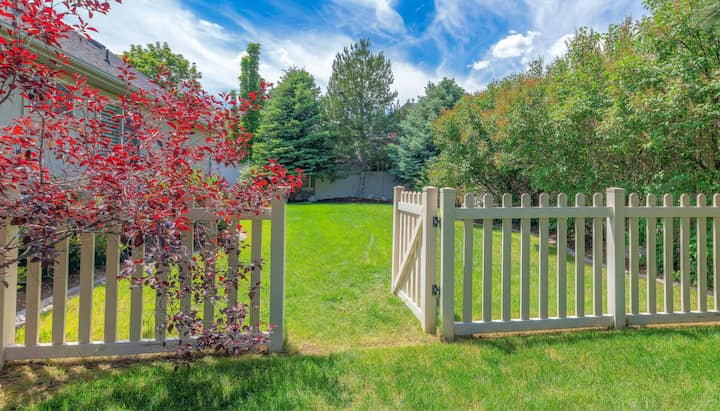 A functional fence gate providing access to a well-maintained backyard, surrounded by a wooden fence in Oklahoma City